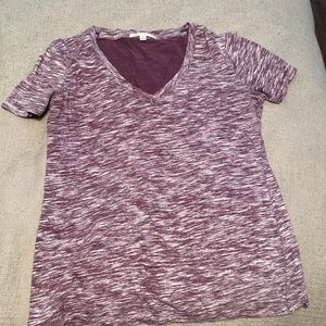 Small, purple v-neck shirt.